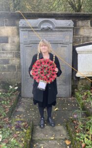 The Mayor of Todmorden holding a wreath at the Remembrance service.
