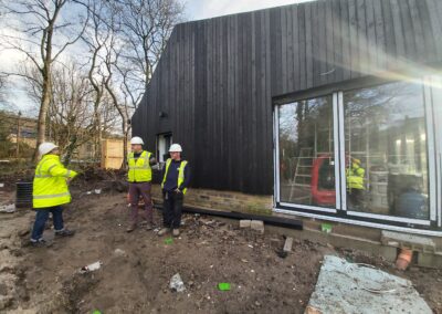 Photo of the Pavilion being built, with contractors in the foreground